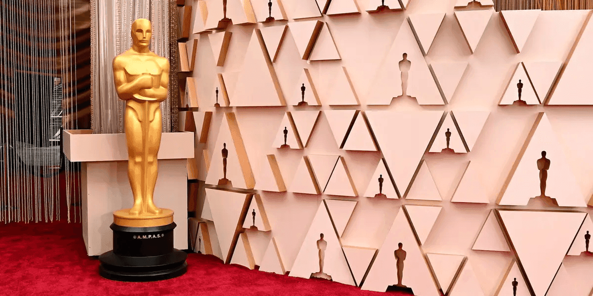 The iconic gold Academy Awards statue stands idle on a red carpet before the awards ceremony.
